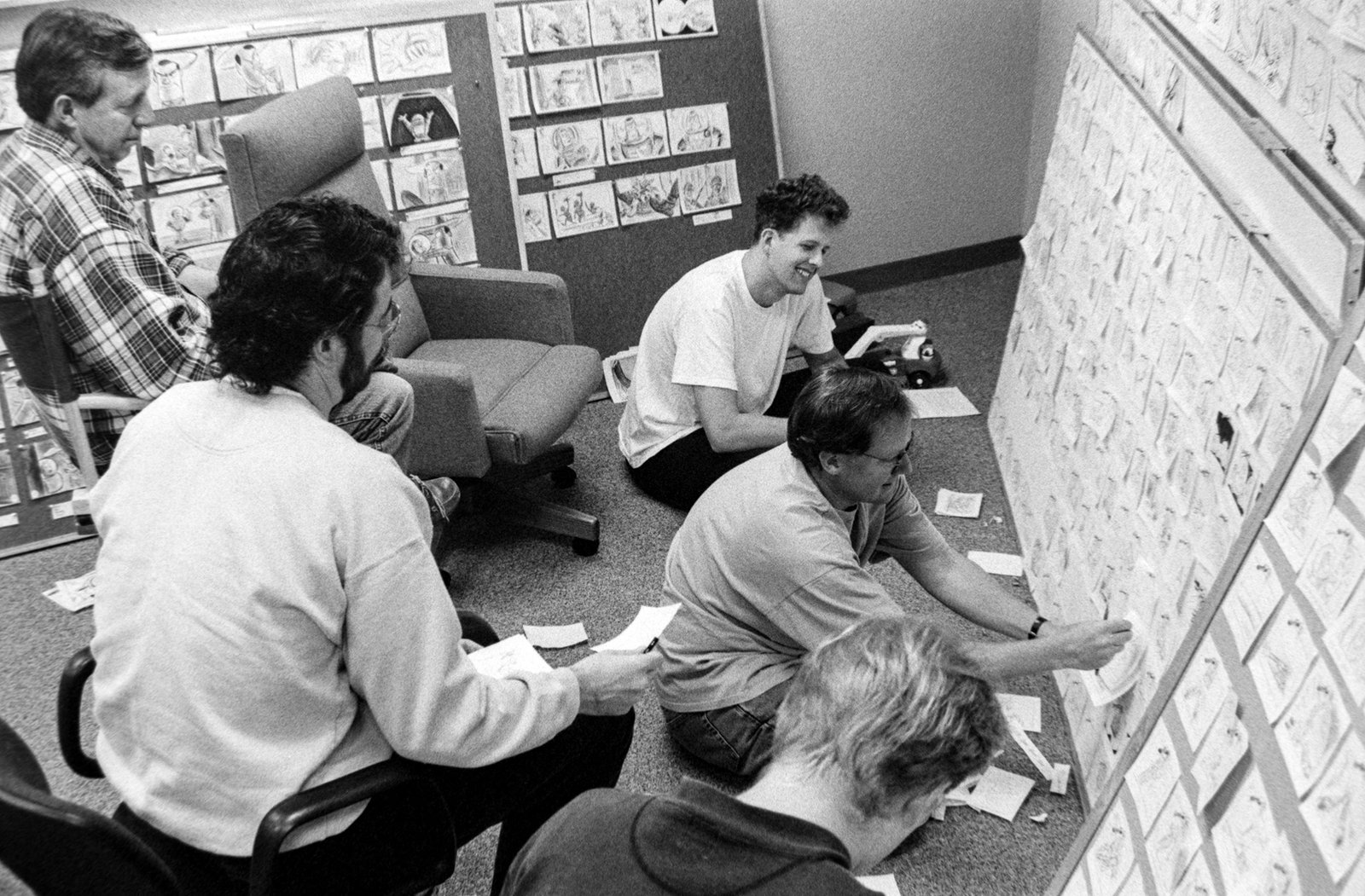 Pixar story team rearranging beat cards pinned to a wall