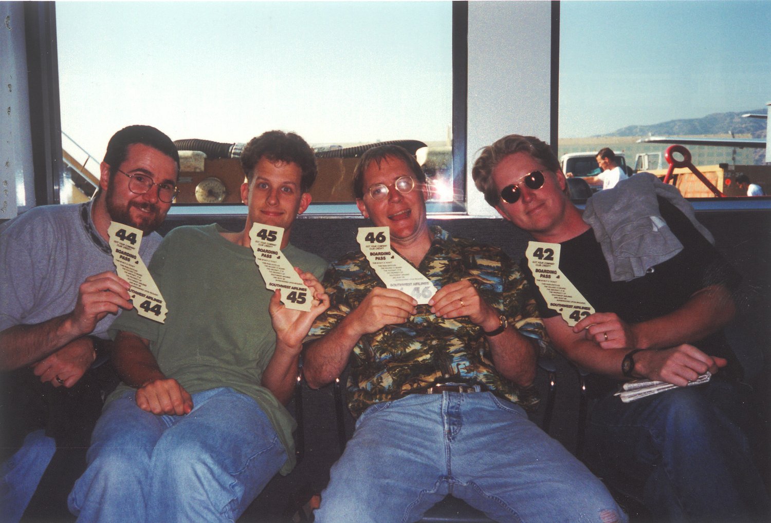 The four filmmakers at an airport holding Southwest boarding passes