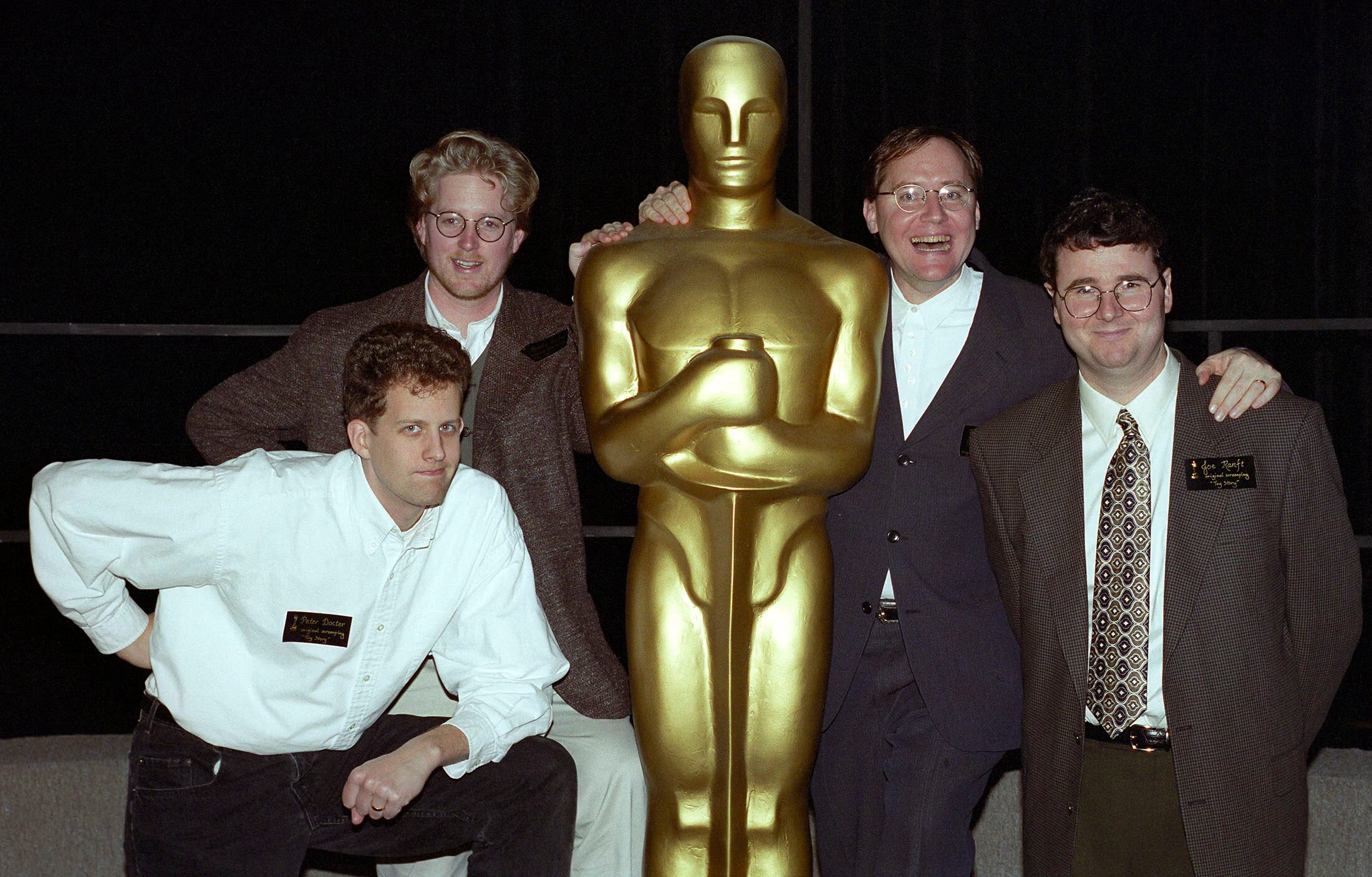 The four filmmakers at an Oscar luncheon with a full-size Oscar statuette